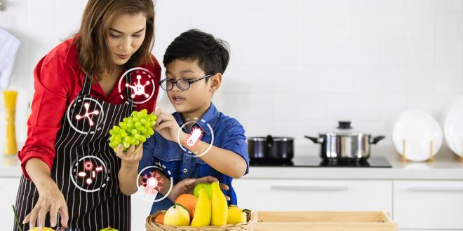 A mother and son in the kitchen choosing probiotic fruits