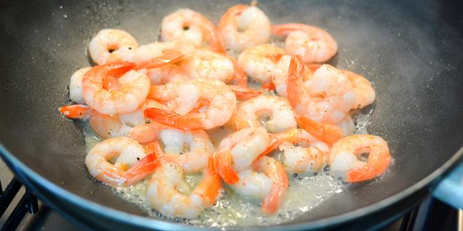 deveined shrimp frying in a hot wok