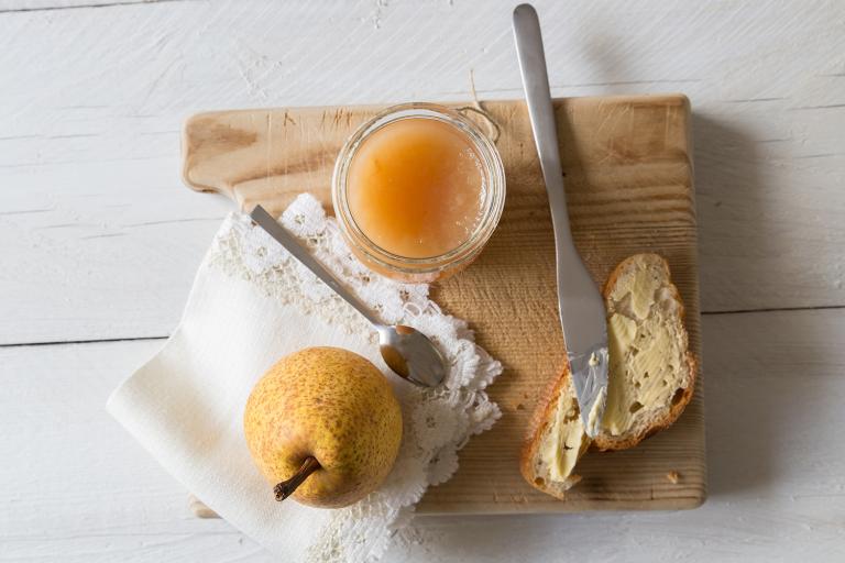 a jar of pear butter with some toast