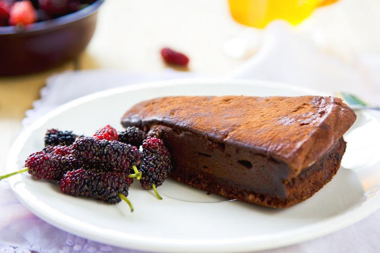 Chocolate truffle torte by berries and tea.